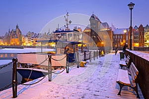 Snowy winter in the old town of Gdansk with frozen Motlawa river, Poland