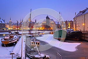 Snowy winter in the old town of Gdansk with frozen Motlawa river, Poland
