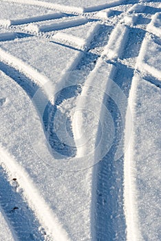 Snowy winter road with tire markings