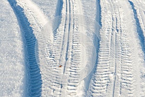 Snowy winter road with tire markings