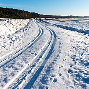 Snowy winter road with tire markings