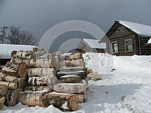 Snowy winter in the village. Wooden house.