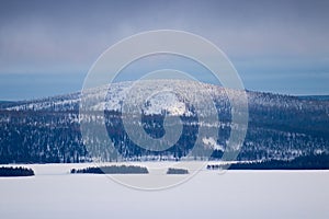 A snowy and wintery fell over lake Kitka near Kuusamo photo