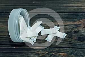 Snus box with nicotine pouches on wooden background. photo