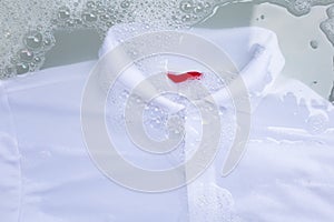 Soak a cloth before washing, white polo shirt.