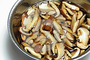 Soak thin sliced dried shiitake mushrooms in water