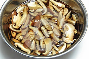 Soak thin sliced dried shiitake mushrooms in water