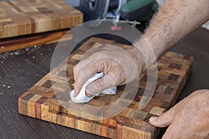 Soak a wooden cutting board with mineral oil using a swab