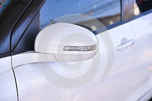 soaking side mirror of white car
