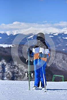 Soaking Up the Sun - young skier enjoys a sunny day on the slopes. Negative space for text