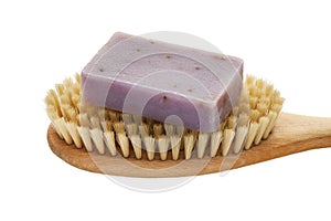 Soap bar with natural ingredients on massage brush