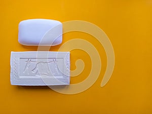 Soap bar on yellow background.