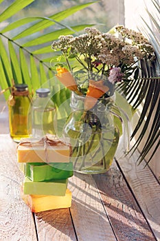 Soap, a bouquet of healing herbs in a glass jug on a wooden windowsill, natural cosmetics, the concept of a healthy lifestyle