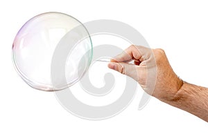 soap bubble and a males hand with needle to let it pop