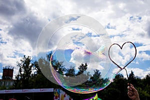 large soap bubble in the shape of a heart in the sky