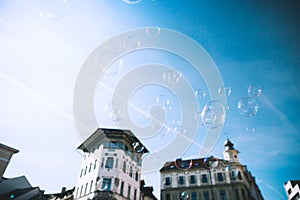 Soap bubbles against sky and buildings of historic center of Lju