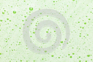 Soap bubbles and bulbs on a green background. Natural and organic detergent