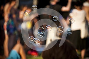 Soap Bubbles With Crowd In Background At Summer Music Festival