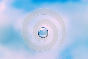 Soap bubbles floating in a blue sky background