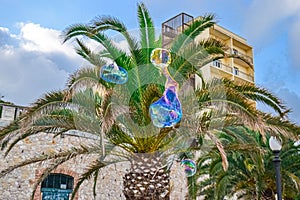 Soap bubbles in front of a palm tree in Spain