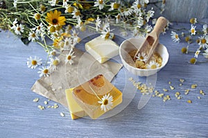 Soap with chamomile, bouquets of fresh chamomile flowers and sea salt