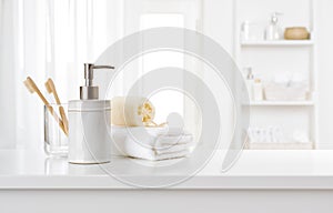 Soap dispenser, toothbrushes and white towel on bathroom counter interior photo