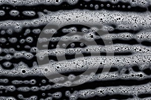 Soap foam on black. Abstract background of cleaning agent.