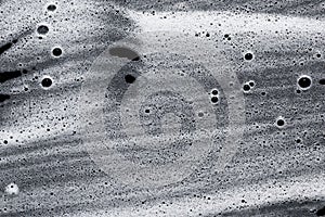 Soap foam on black. Abstract background of cleaning agent.