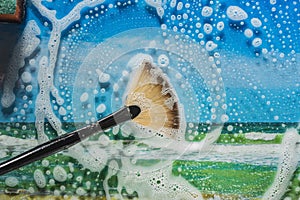 Soap foam on glass- cleaning of contaminated surfaces. Clean background- clipart photo