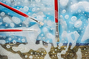 Soap foam on glass- cleaning of contaminated surfaces. Clean background- clipart photo