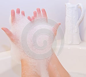 Soap foam on hands in bath