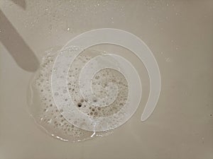 Soap foam in the sink after handwashing