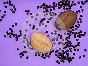 Soap in the form of coffee on a purple background with coffee beans
