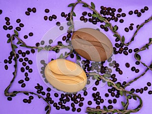 Soap in the form of coffee on a purple background with coffee beans and a decorative cord