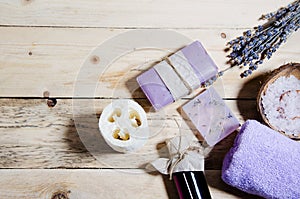 Soap with lavender, oil, flavored salt, a bouquet of lavender lie on a wooden surface. Body and face care. CPA attributes.