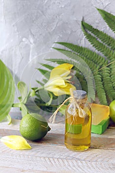 Soap, limes, aromatic oil on a wooden table