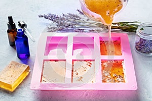 Soap making at home. Liquid glycerin with the additives of peels and flowers