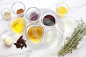 soap making ingredients: oil, lye, herbs, and colorants on a white surface photo