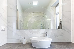 Soap and shampoo dispensers near Ceramic Water tap sink with faucet in expensive loft bathroom