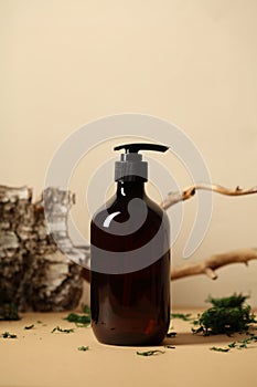 Soap or shampoo pump bottle with bark, tree branch, green moss. SPA natural cosmetic concept