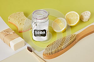 soap, sponge, soda in a labeled jar, lemon and a wooden brush