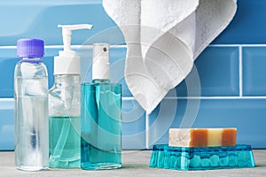 Soap and toiletries on shelf in blue bathroom