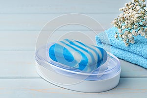 Soap and toiletries on shelf in blue bathroom