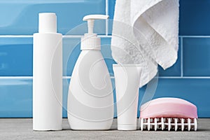 Soap and toiletries on shelf in blue bathroom