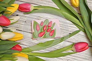 Soap among the tulips on the table