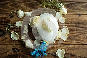 Soap and white rose and petals on a wooden background