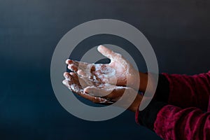 Soaped hands of a person - importance of washing hands during the coronavirus pandemic