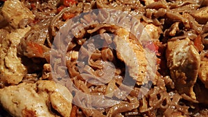 Soba with chicken breasts and vegetables in the process of stewing