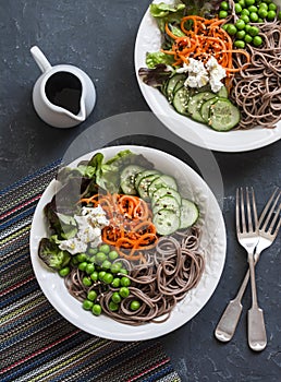 Soba noodles buddha bowl. Buckwheat noodles with vegetables on a dark background, top view. Vegetarian healthy food