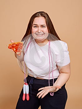 Sobbing overweight girl try to overcome herself and not to eat pizza